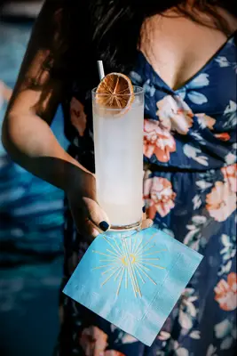 Wedding guest holding Fresh Citrus Mélange wedding mocktail