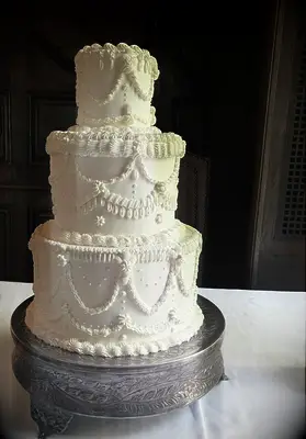White tiered piped wedding cake