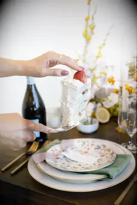 Woman cutting a slice of a sponge cake