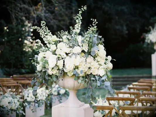 ceremony flower arrangement in urn with stock blooms