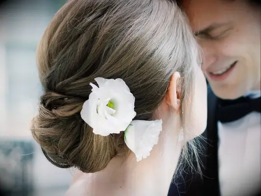bridal updo with fresh white lisianthus blooms