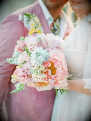 bride holding pastel peony bouquet
