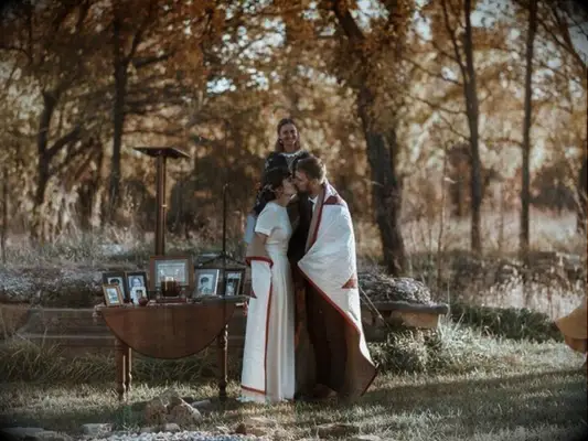 couple kissing during blanket ceremony at Native American wedding ceremony