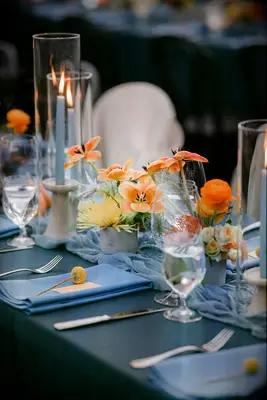 Vibrant orange, yellow and blue centerpieces garden wedding idea
