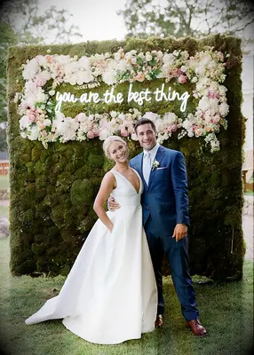 Moss wall with custom neon sign garden wedding idea
