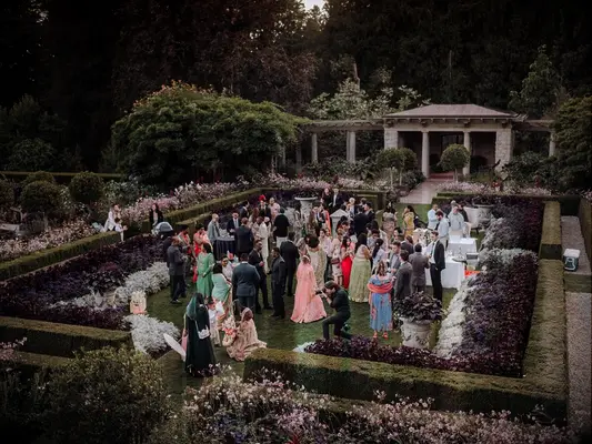 Guests mingling at outdoor whimsical garden wedding