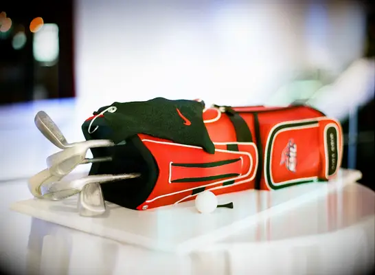 Red golf-bag shaped cake. 