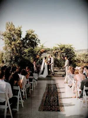 Bohemian rug aisle runner at boho wedding