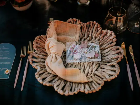 Rattan place setting at boho wedding