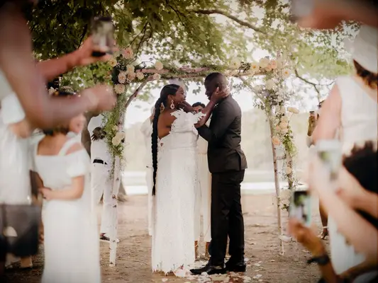 Pink floral wedding arch at boho wedding