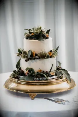 Greenery adorned cake at boho wedding