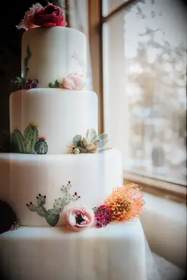 Hand-painted cactus cake at boho wedding