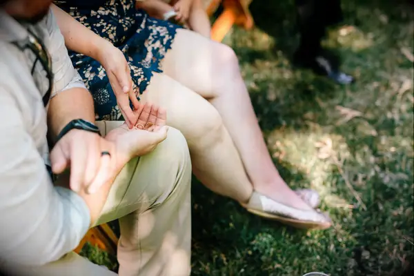 wedding guests pass the wedding rings among themselves for a ring warming ceremony