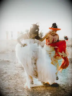 couple jumping broom during wedding