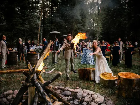 Bride and groom lighting bonfire during wedding unity ceremony