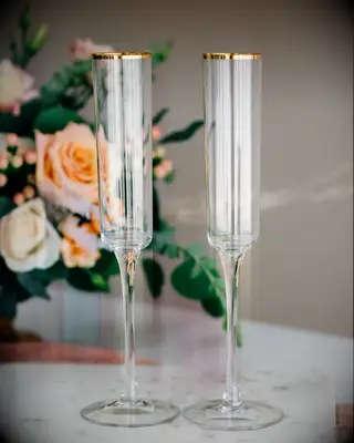 modern elongated wedding champagne flutes with engraving and gold rim