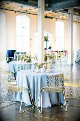 Gold metallic chairs with blue table cloths