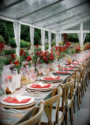 Wood farm tables with red napkins