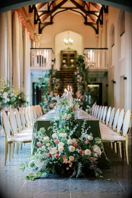 Gold and white chairs with beautiful rose displays