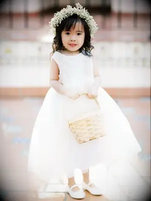 A wedding flower girl with a baby