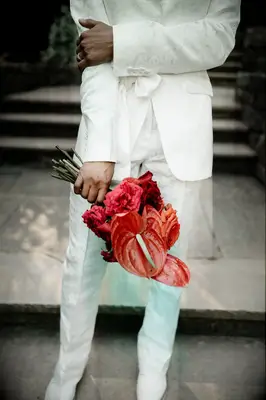 Man holding a bouquet of Anthurium flowers