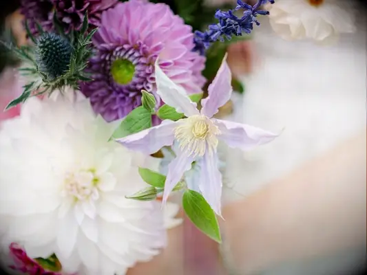 A wedding bouquet with purple clematis flowers