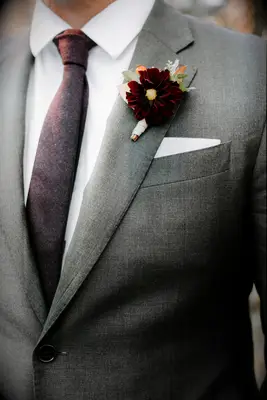 A romantic wine-colored cosmo flower boutonniere