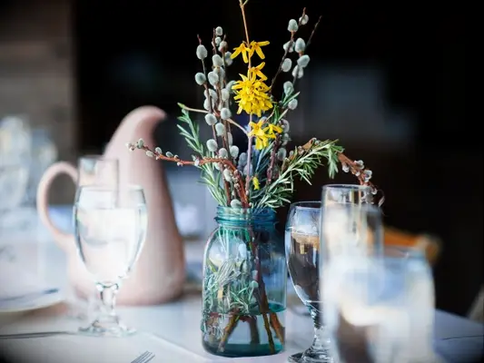 A mason jar with forsythia branches