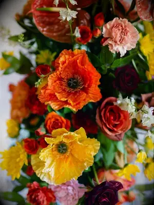 A wedding flower arrangement with orange Icelandic poppies