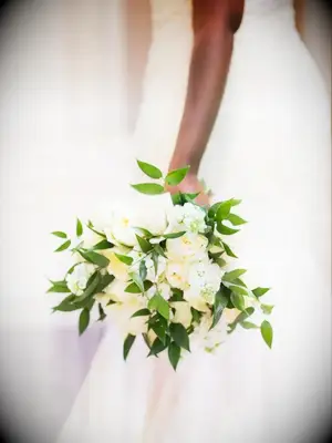 Bride holding bouquet with Ruscus and roses