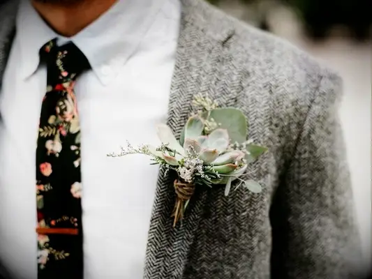 Groom with wool suit jacket and succulent boutonniere