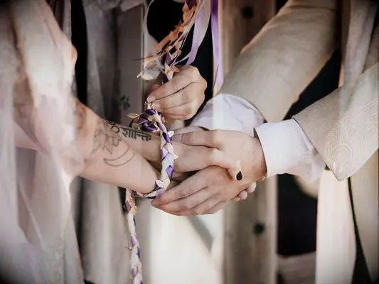 handfasting ceremony with purple ribbon