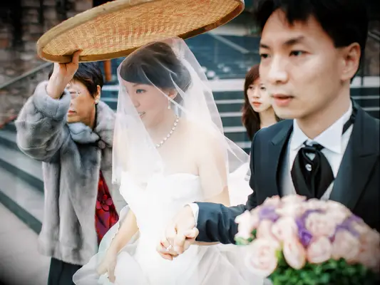 Rice sieve held over bride during wedding
