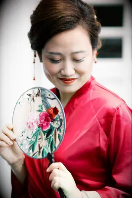 Chinese bride holding ornate fan