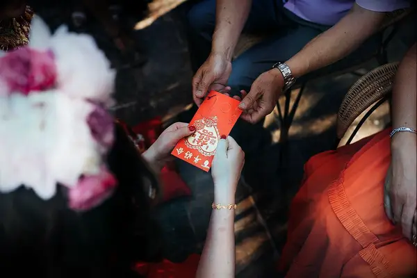 Red envelope being passed during Chinese wedding ceremony