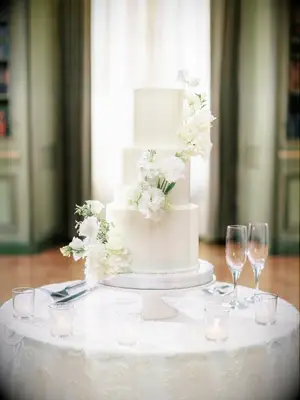classic white wedding cake with white cake flowers