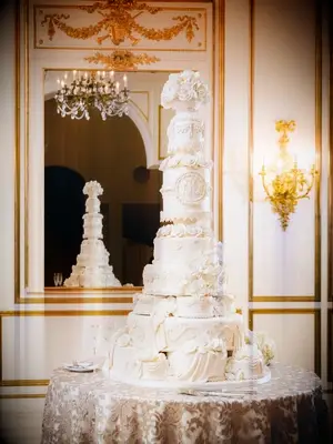 dramatic towering white wedding cake with intricate piping