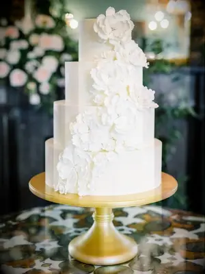 white cake on gold cake stand