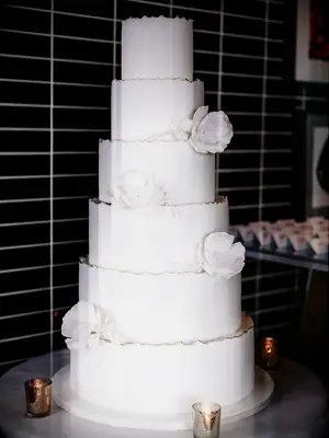 six-tier white wedding cake with sugar flowers