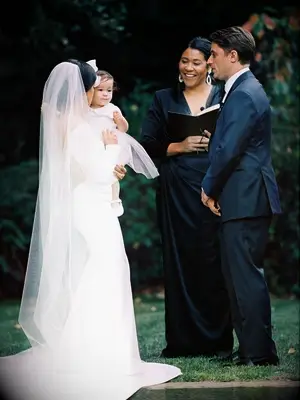 couple with baby during wedding ceremony