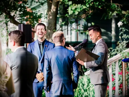 groom laughing during wedding ceremony