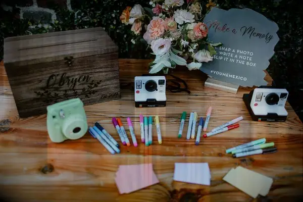Table with pens and Polaroid cameras