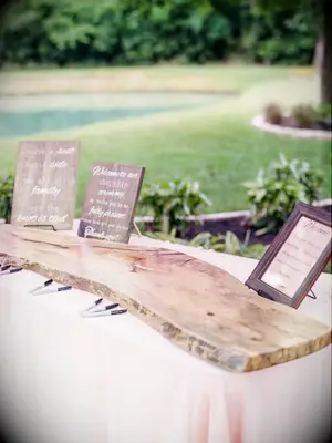 Plank of wood sitting on table for guest book