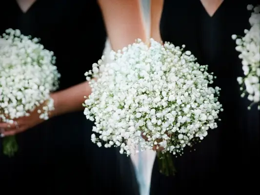 bridesmaids in black dresses holding baby