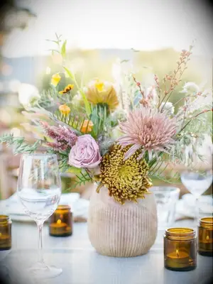 yellow chrysanthemum arrangement in beige vase
