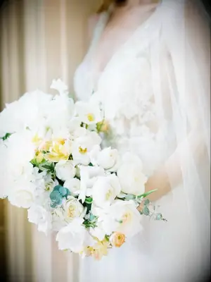 Bride holding white bouquet with fringe tulips