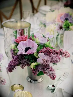 purple lilac and anemone floral design in silver mint julep cup