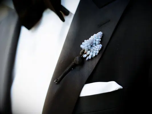 blue Muscari boutonniere on black tux lapel