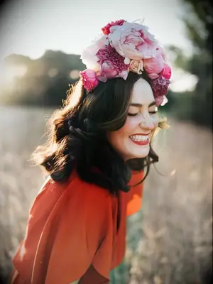 bride in red dress with pink peony flower crown