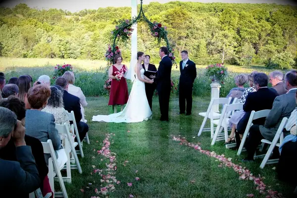 A couple tie the knot at an outdoor ceremony at Ladew Topiary Gardens in Monkton, Maryland